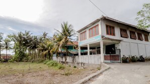 A two-story building with a sign reading "Sleman Darusnawati Losmen Park Hotel". - Losmen Parikesit (Parangtritis)