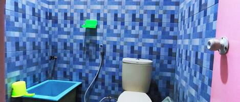 A bathroom with a toilet, a shower, and a bathtub.