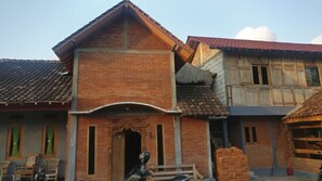 A traditional brick building with a gabled roof and a wooden door. - Jogo Segoro Homestay (Wonosari)
