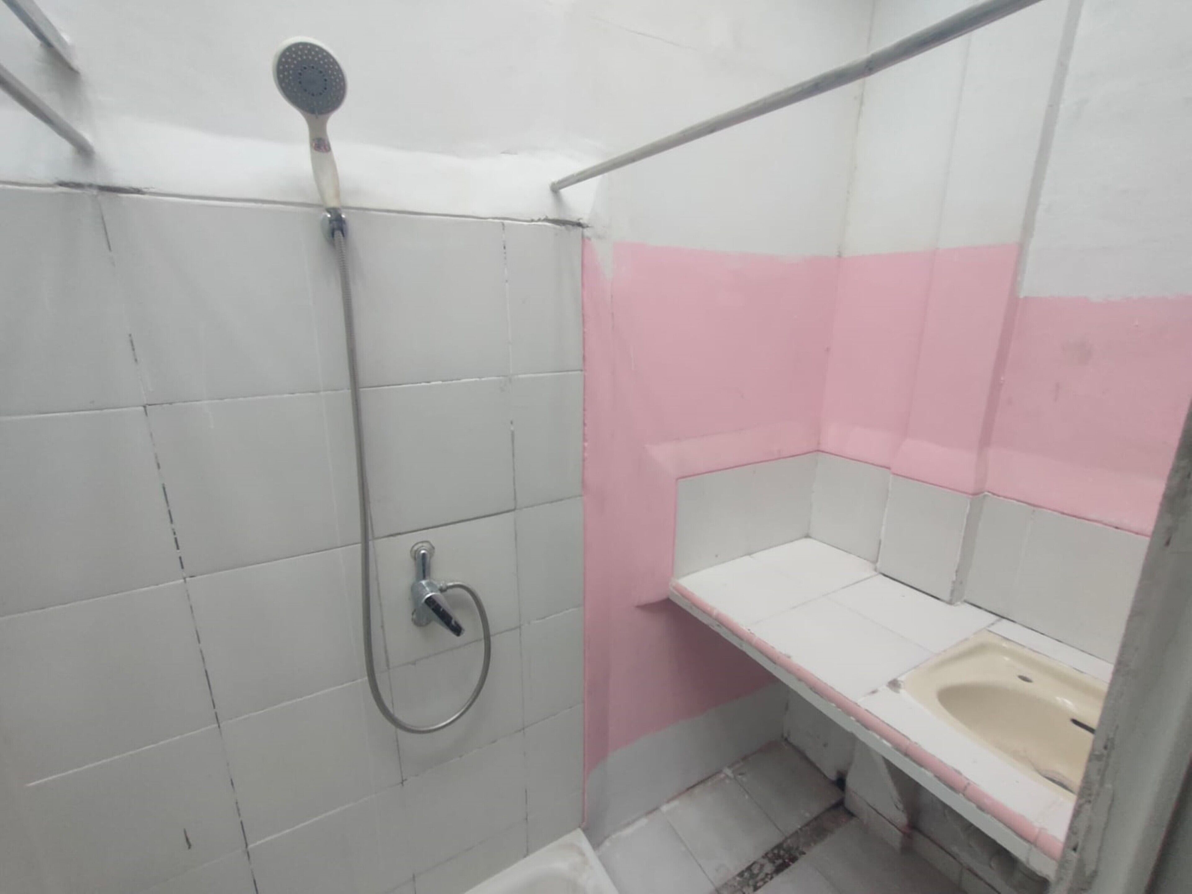 A small bathroom with a shower, a toilet, and a sink.