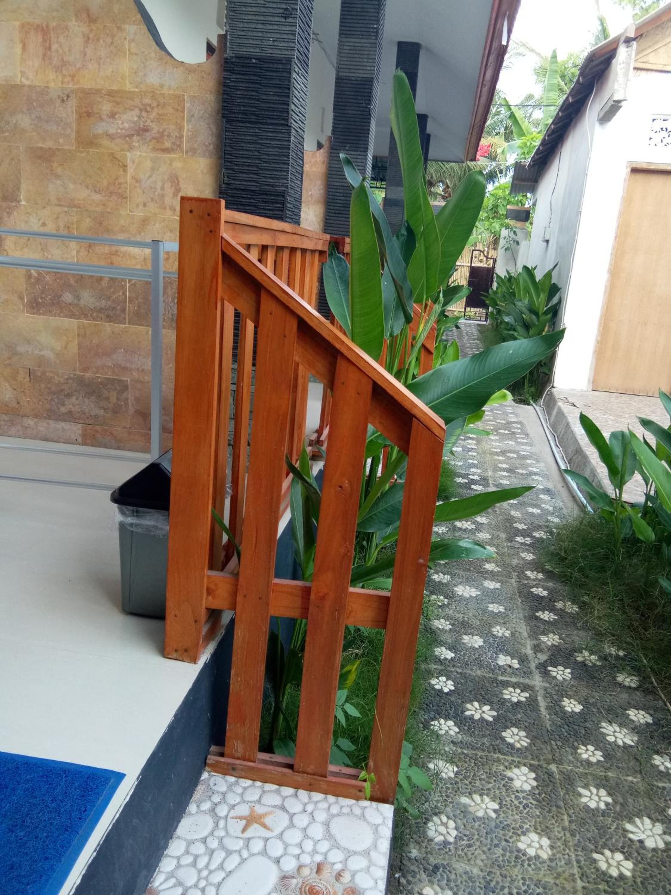 A wooden staircase leading to a tiled area with a starfish decoration.