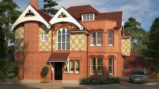 A two-story brick house with a prominent chimney, large windows, and a driveway with a parked car. - Opulence (Bournemouth)