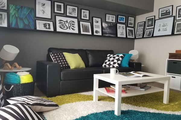 The chic living room features art galleried walls. TV and free Netflix.
