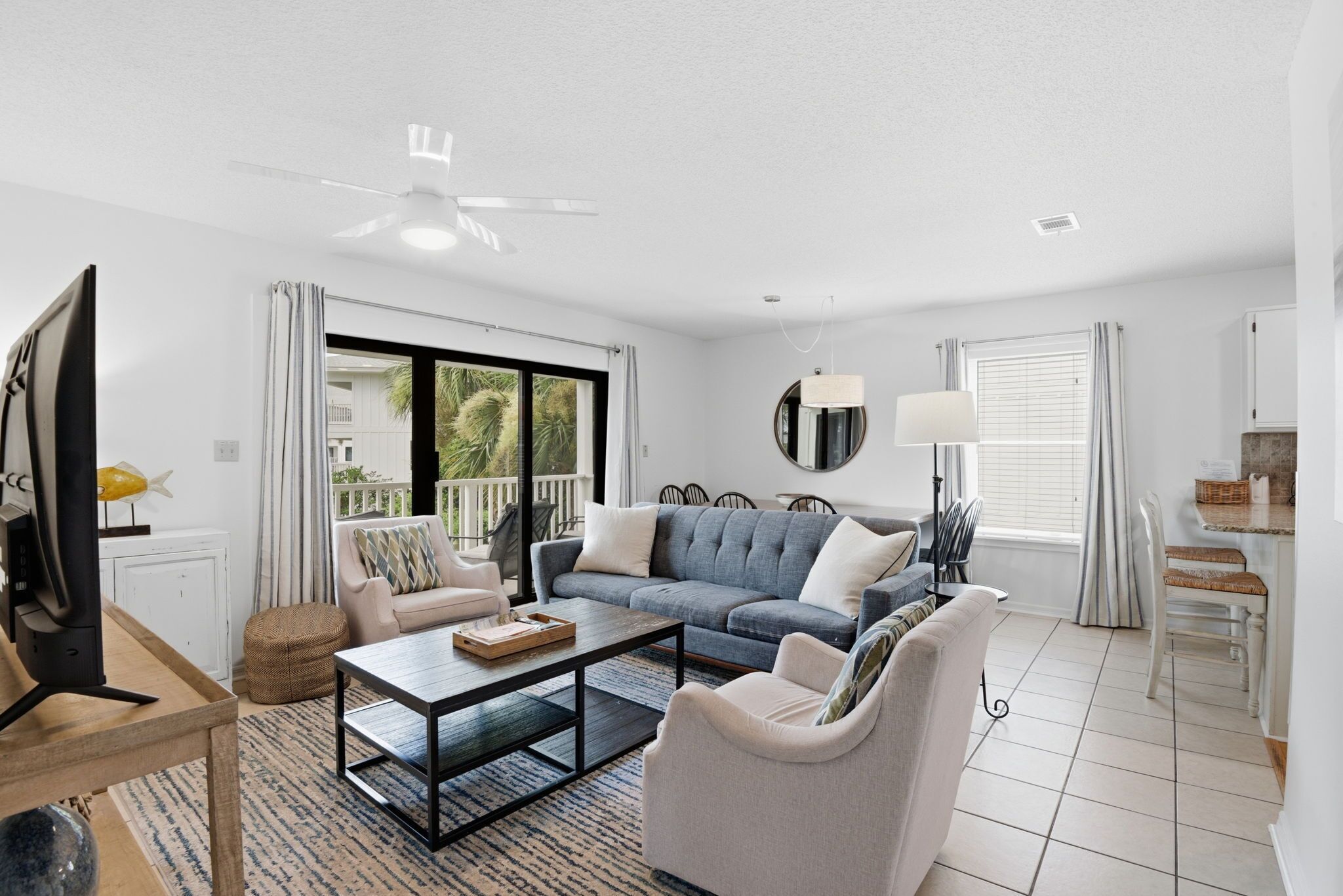 A modern living room with a sofa, coffee table, and TV.