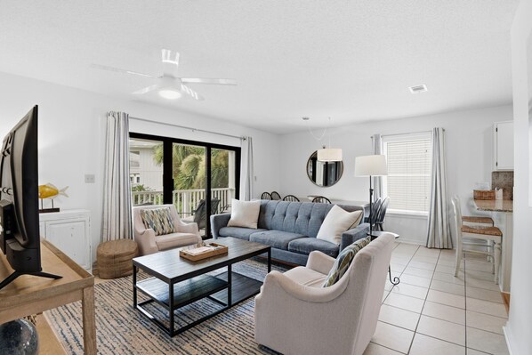 A modern living room with a sofa, coffee table, and TV.
