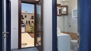 A bathroom with a toilet, sink, and mirror. - I tre Golfi Paprica (San Vito Lo Capo)