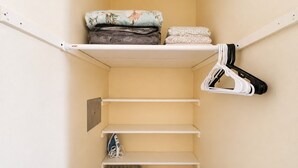 A storage closet with shelves, a radiator, and hanging storage. - Cozy Gulfport Studio with King Bed + Full Kitchen walkable to Beach Blvd (Gulfport)