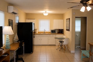 A compact kitchen with a refrigerator, microwave, and sink. - Cozy Gulfport Studio with King Bed + Full Kitchen walkable to Beach Blvd (Gulfport)