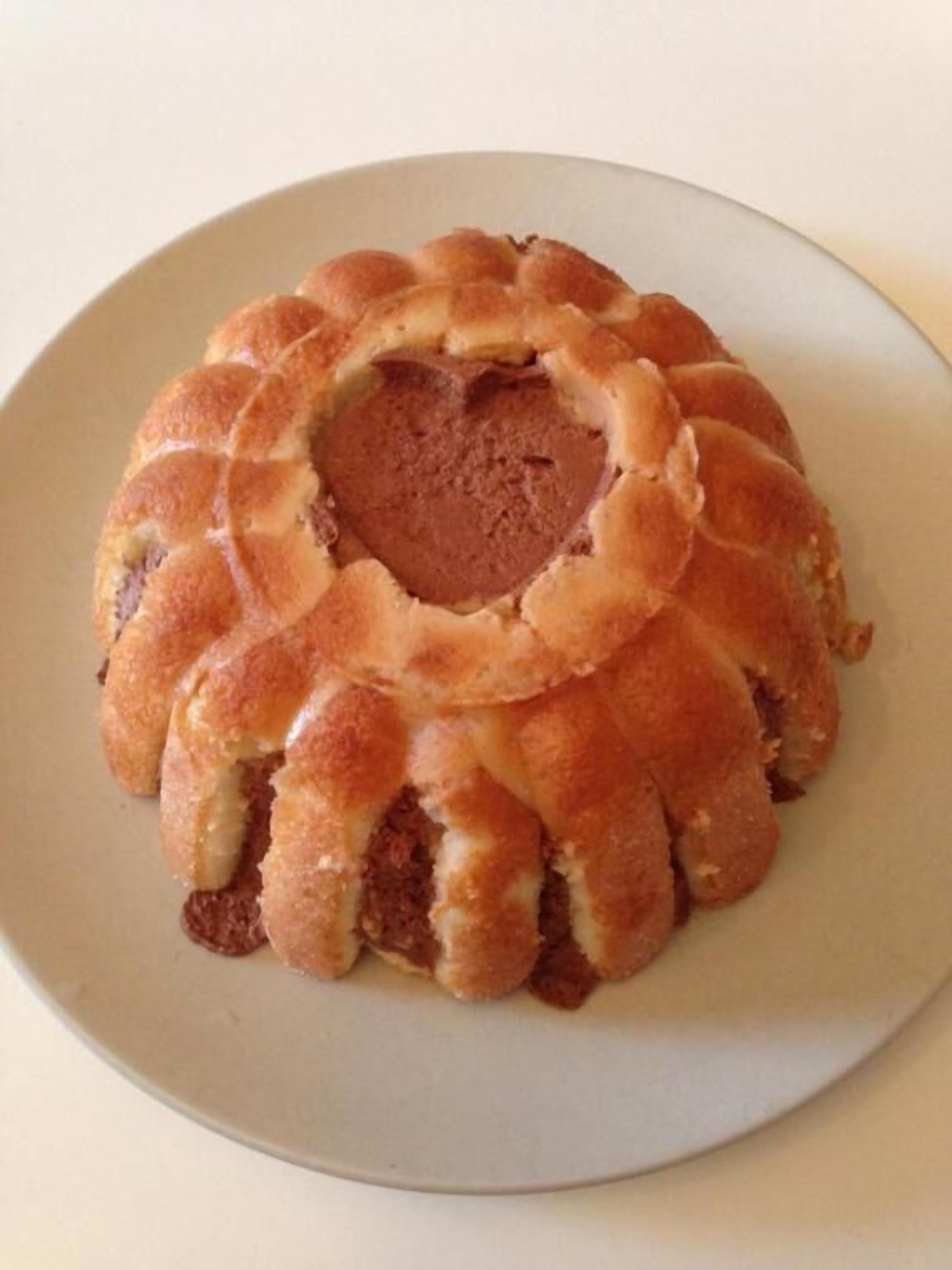 A round cake with a heart-shaped center on a plate.