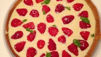 A round pie with strawberries on top.