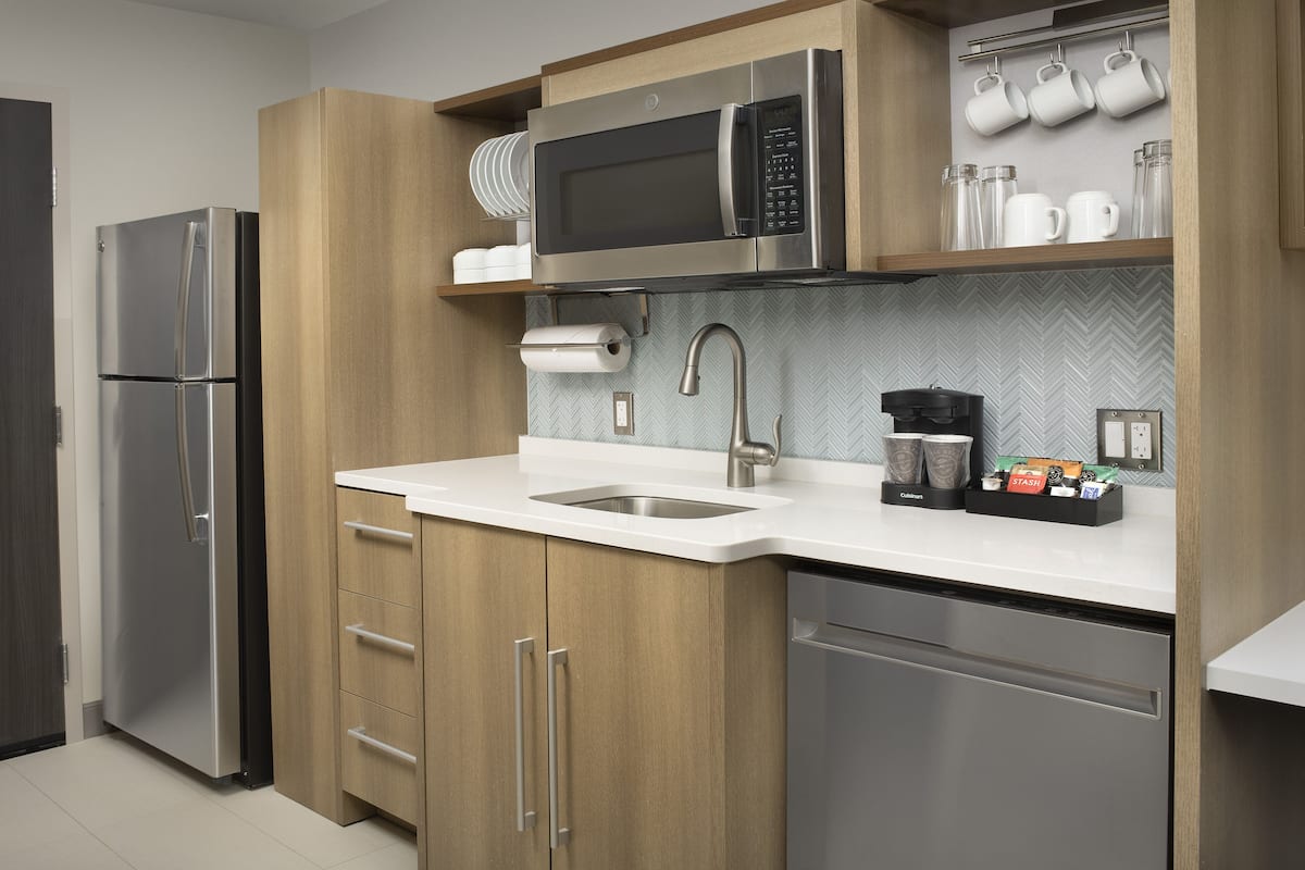 full-sized fridge, microwave, dishwasher, cookware/dishes/utensils