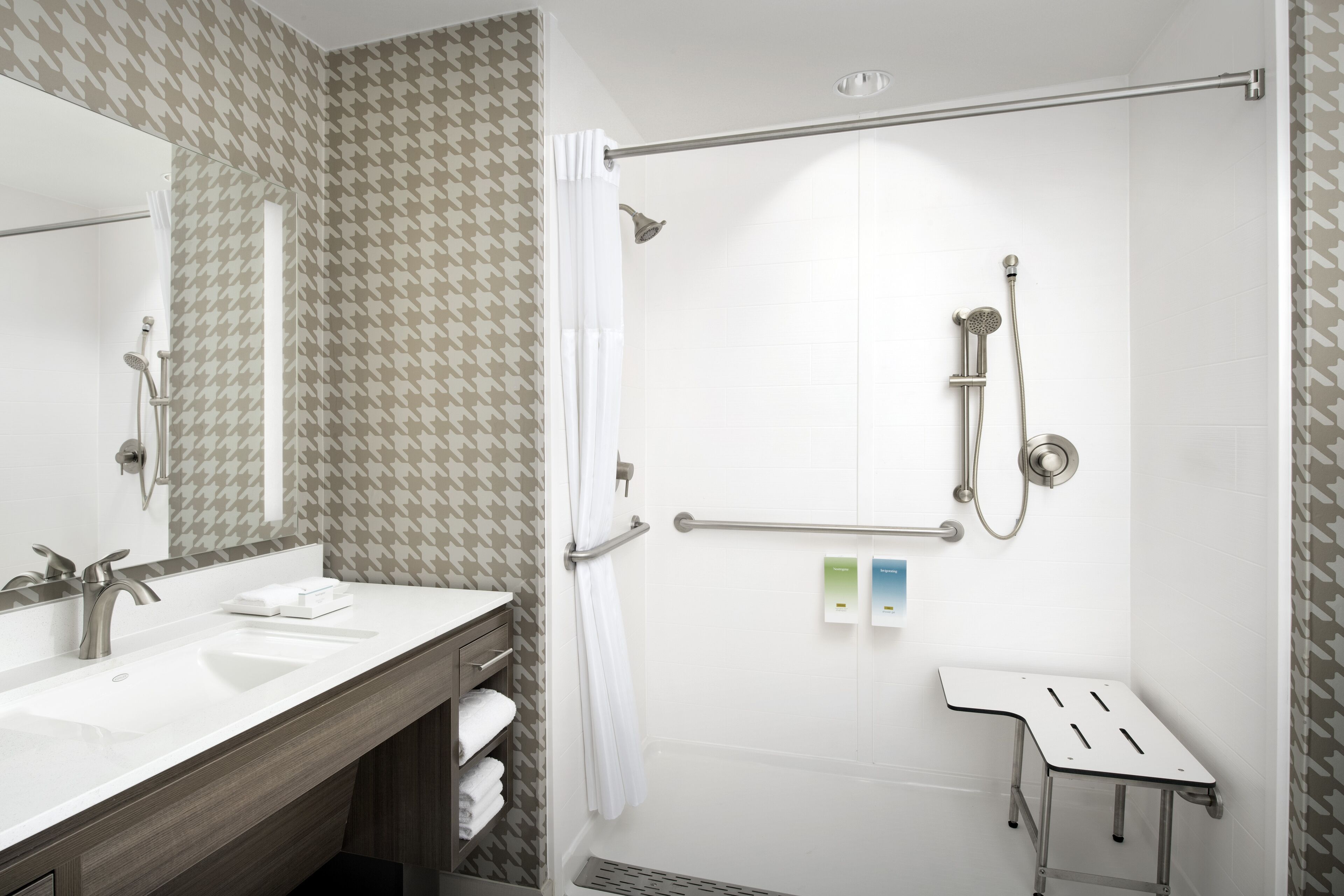 A modern bathroom with a shower, a vanity with a sink, and a mirror.