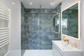 Shower, hair dryer, towels, toilet paper
