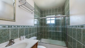 A bathroom with a shower, toilet, and sink. - Caicos Cactus Residence  Major Hill (Caicos Islands)