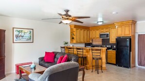 A compact living space with a kitchenette, a dining area, and a seating area with a sofa and chairs. - Caicos Cactus Residence  Major Hill (Caicos Islands)