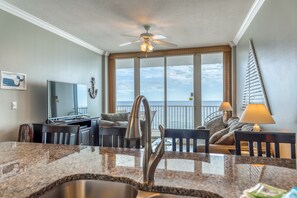 Enjoy ocean views from the large windows in this kitchen, which features a dining area and modern appliances.