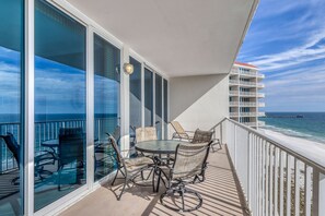 Enjoy ocean views from this balcony with a round table and four chairs.