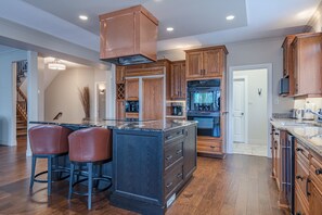 Functional kitchen with a large island and appliances.