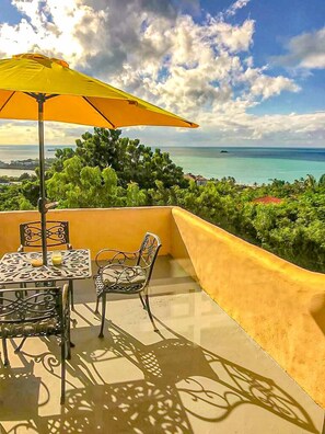 Outdoor dining - Wake up to panoramic views of Dickenson Bay and unwind to spectacular sunsets (St. John's)