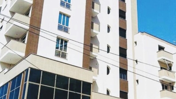 A high-rise building with multiple balconies and a modern architectural design. - Rezidenca Shopi Apartments (Elbasan)