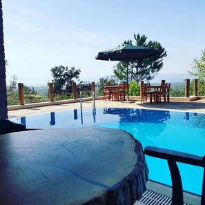 Seasonal outdoor pool, open 9:00 AM to 6:00 PM, pool umbrellas