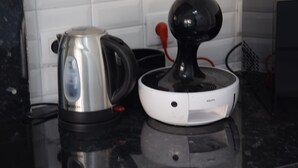 A coffee maker and a wireless charging station on a kitchen counter. - The edge of Saint Quentin 10 minutes from METZ at the foot of Mont Saint Quentin (Lessy)