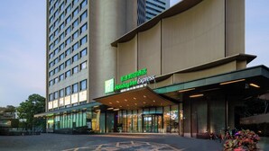 A Holiday Inn Express hotel with a modern facade, large windows, and a prominent entrance. - Holiday Inn Express Shenzhen Dongmen by IHG (Shenzhen)