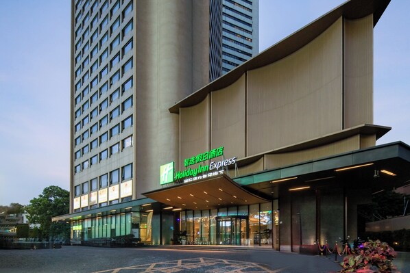 A Holiday Inn Express hotel with a modern facade, large windows, and a prominent entrance. - Holiday Inn Express Shenzhen Dongmen by IHG (Shenzhen)