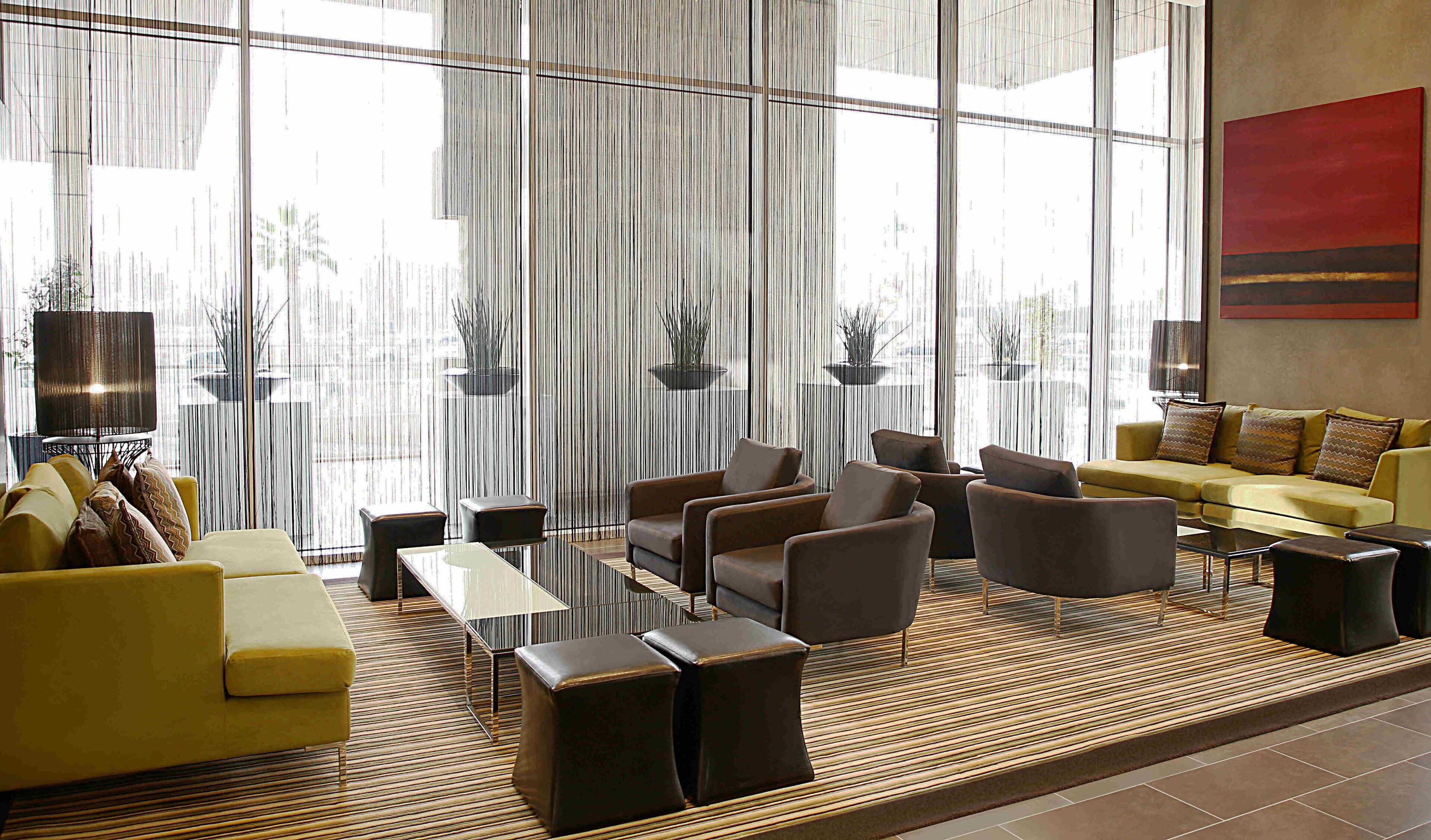 A modern lounge area with sofas, armchairs, and a coffee table.