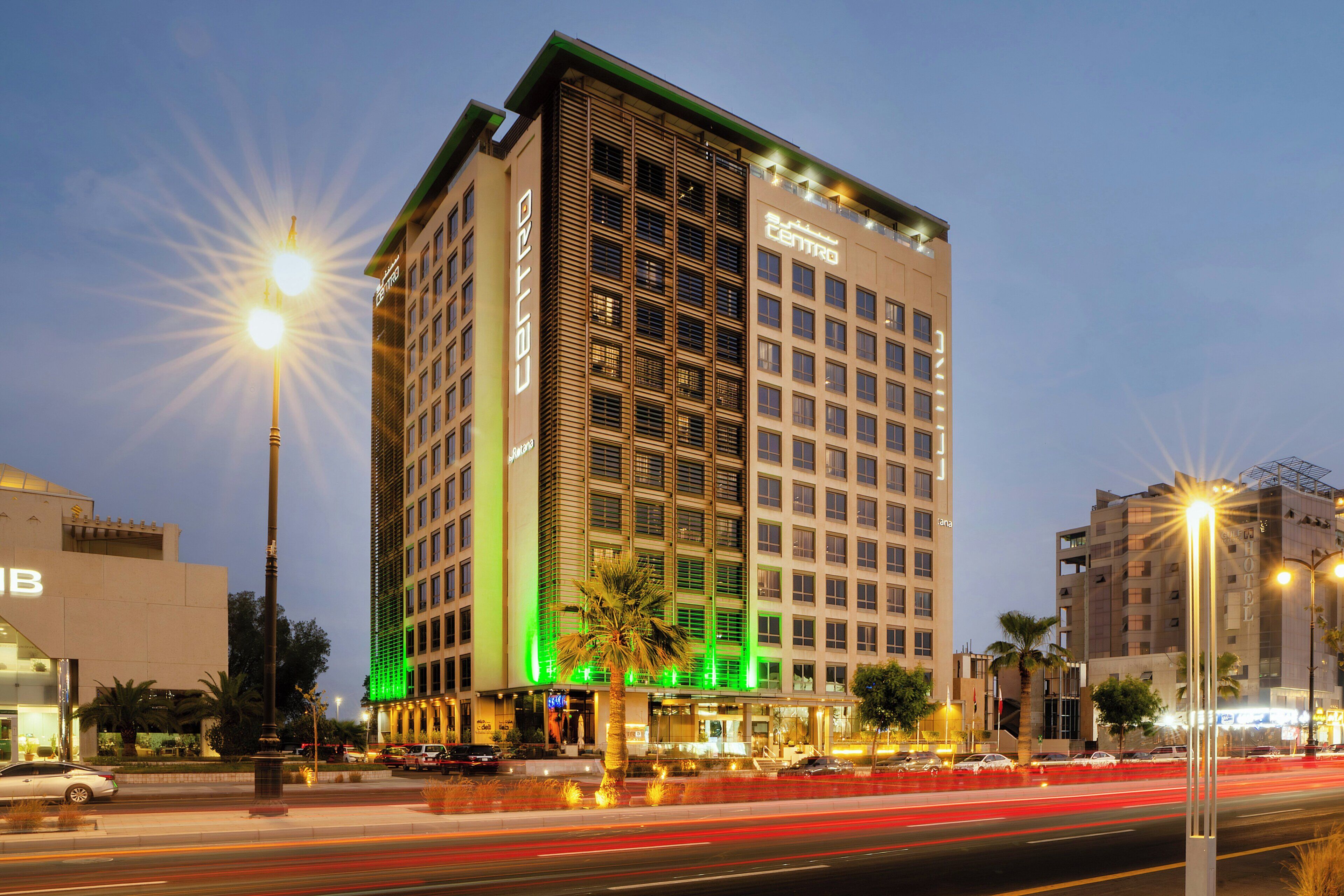 A multi-story hotel with a modern facade, large windows, and a prominent entrance.