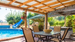 An outdoor patio with a pool, seating area, and a hot tub. - Historic Creswell Farmhouse Pool+New Spa - 13 min to Eugene, U of O, & Wineries! (Creswell)