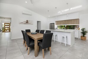 Enjoy meals in the central dining area with a sink and bar.