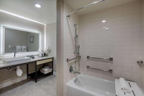 Features a walk-in shower, separate bathtub, and ample storage.
