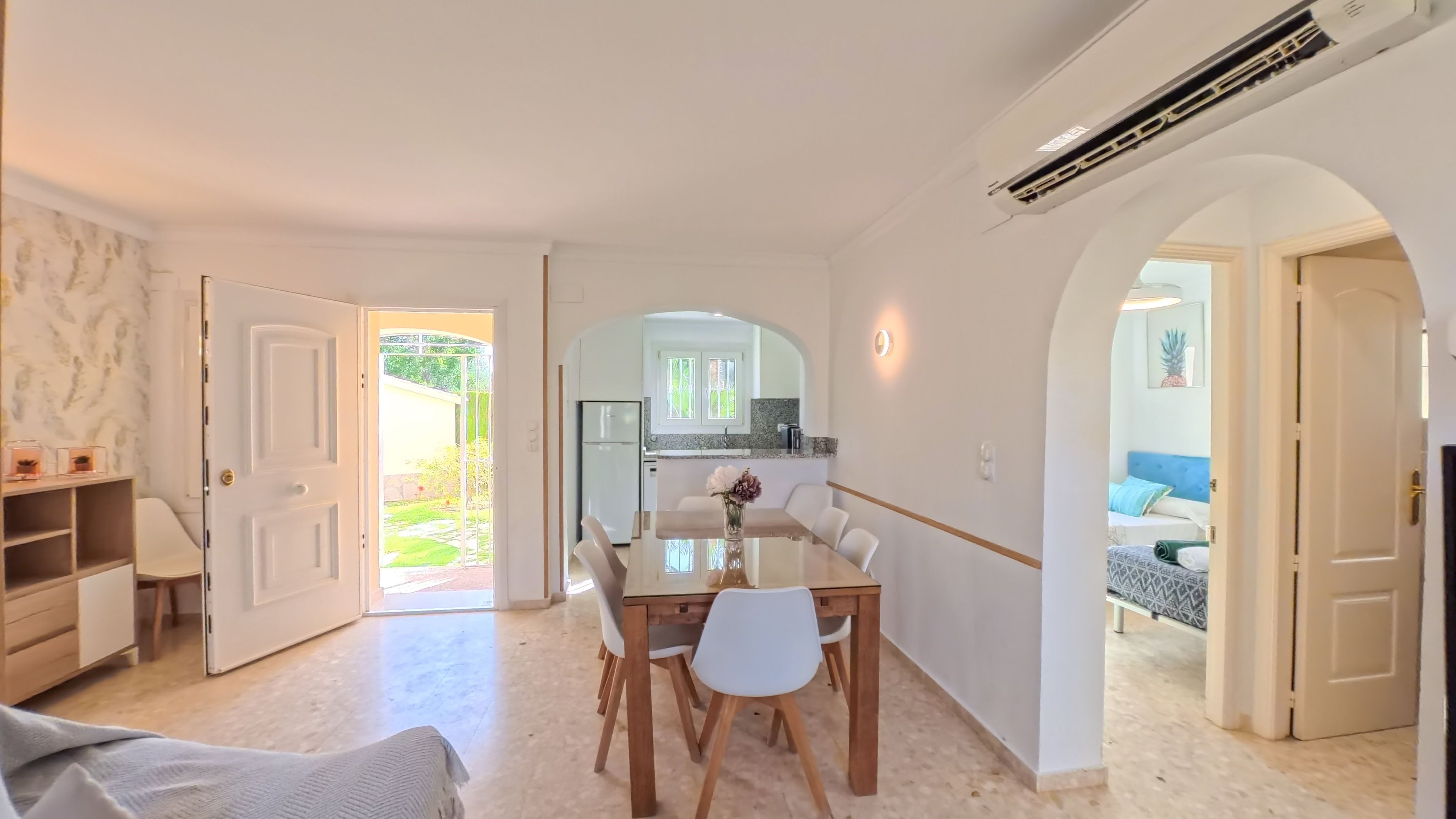 A modern interior with a dining area, kitchen, and living space.