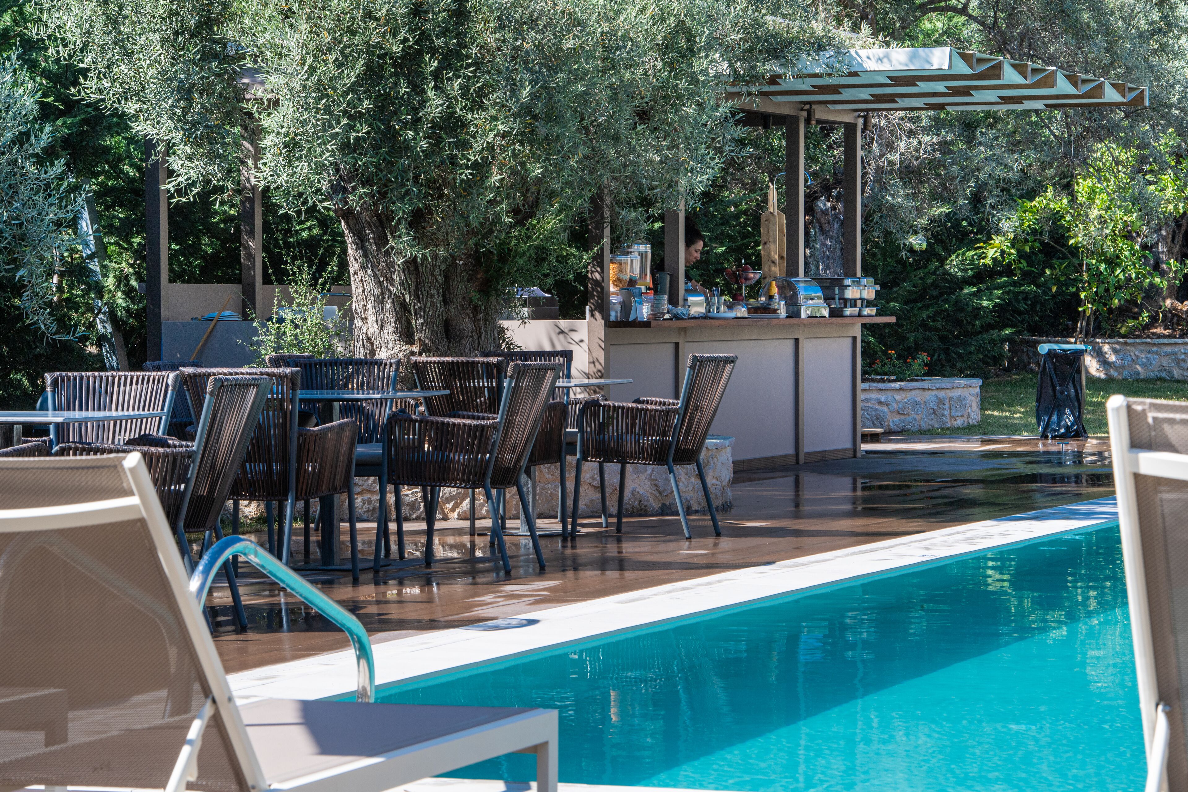 Un espace aménagé au bord de la piscine, avec des chaises longues et un bar.