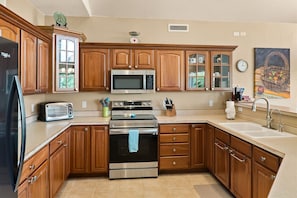 Enjoy cooking in this well-equipped kitchen with a central island, double oven, and microwave.