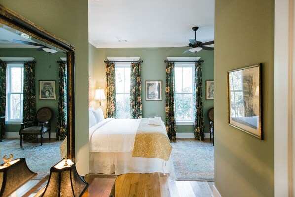 A bedroom with a bed, a ceiling fan, and two windows with curtains. - Upscale Home with Plunge Pool and Private Parking by Lucky Savannah (Savannah)