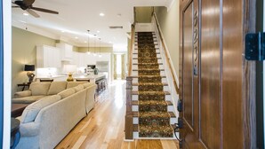 A staircase with a patterned carpet, a wooden handrail, and a door with a number. - Plunge Pool and Parking, 3 Stories in Historic Downtown by Lucky Savannah (Savannah)