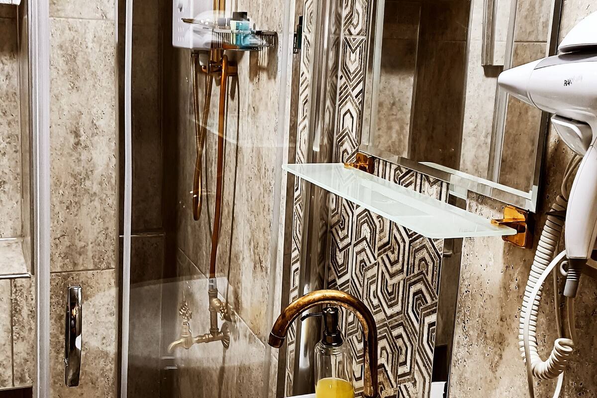 standard double room | bathroom | shower, hair dryer, slippers, towels