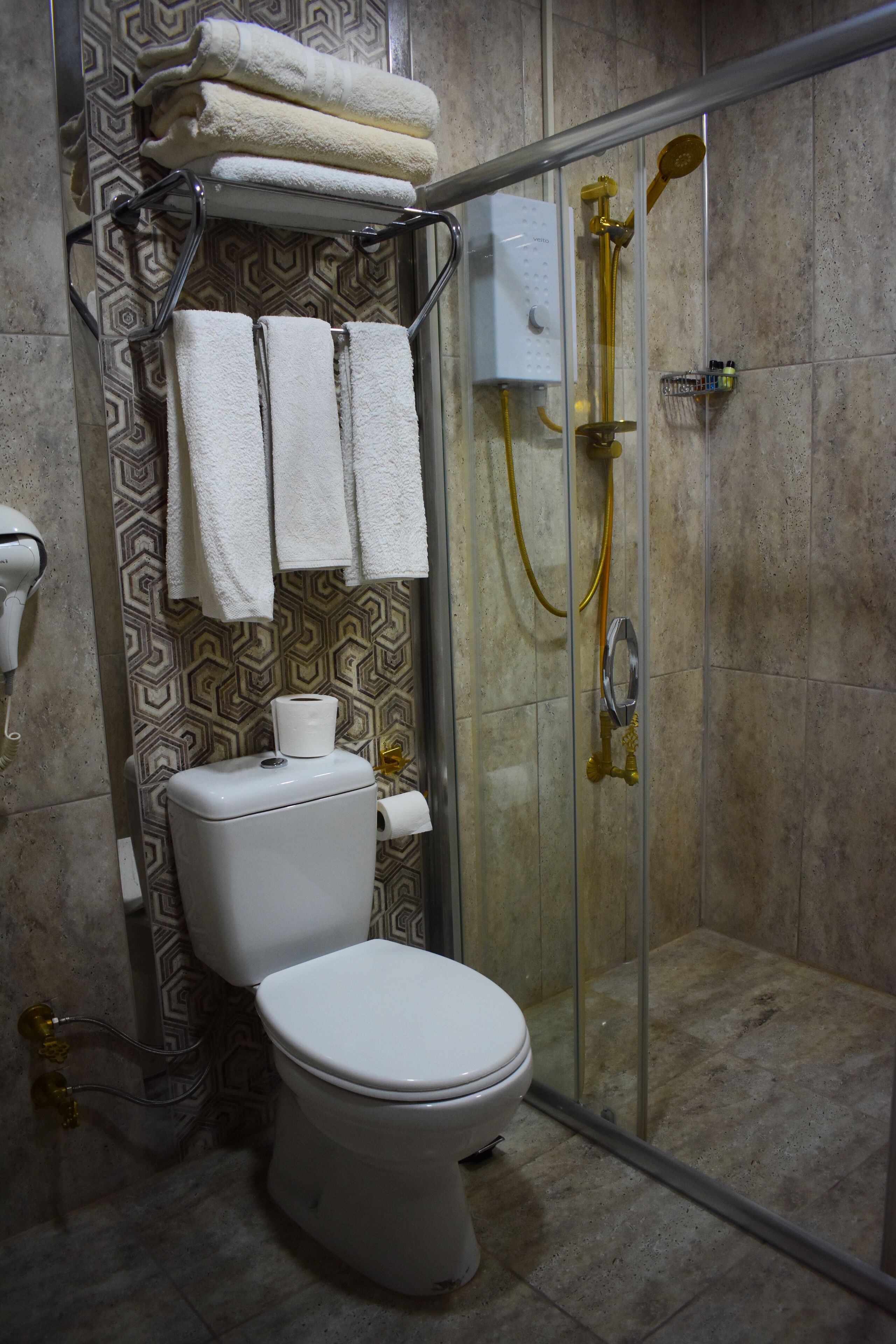 shower, hair dryer, slippers, towels