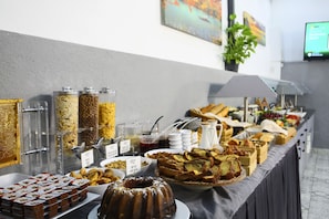 A buffet with various food items, including bread, pastries, and condiments. - Almina Inn Hotel (Istanbul)