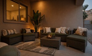 A cozy outdoor seating area with wicker furniture, a large potted plant, and a decorative centerpiece. - Golf Mansion.  Sleeps 16 Golfers, 5 Min to Wolf Creek, Tee Times Handled (Mesquite)