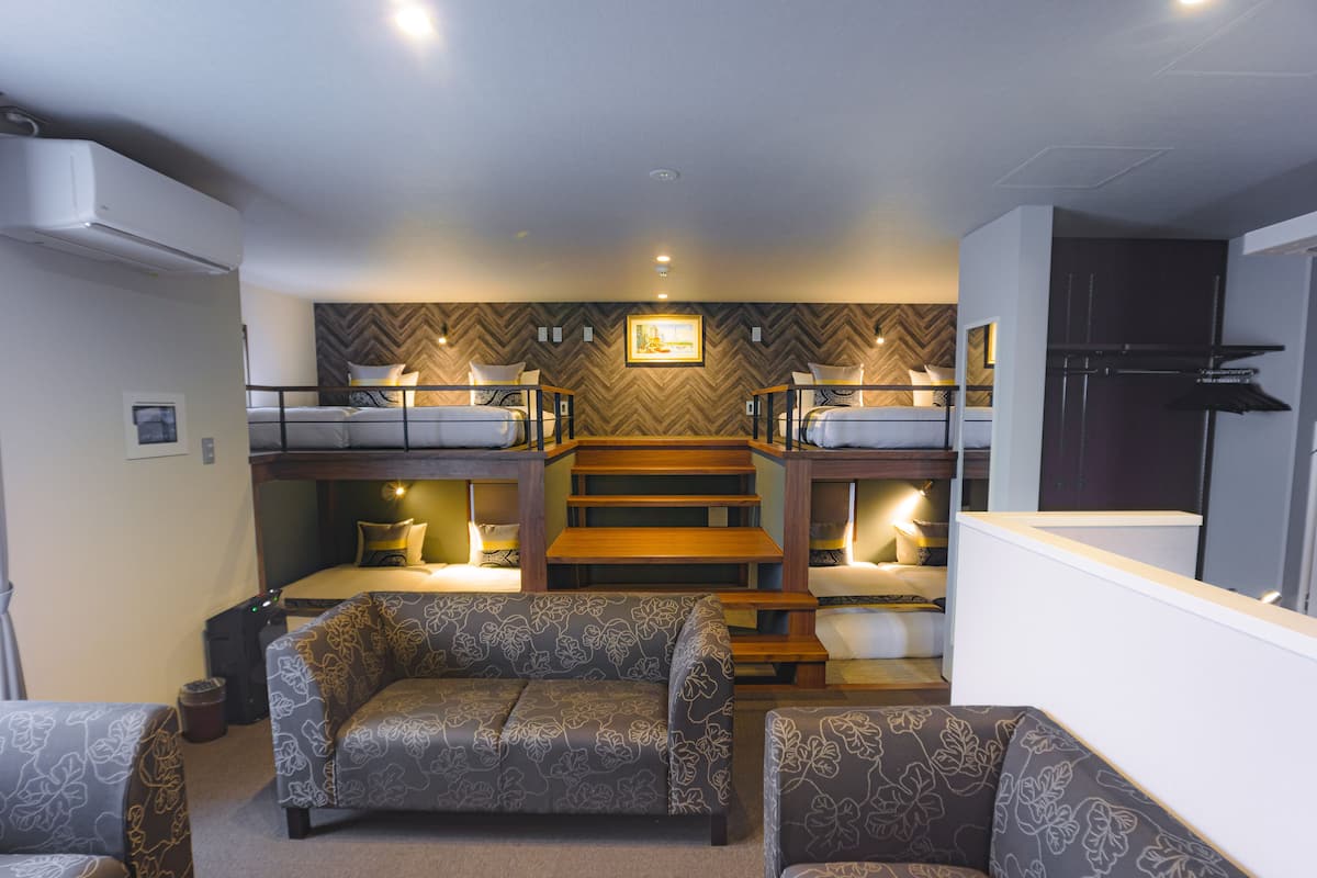 A compact living space with bunk beds, a sofa, and a coffee table.