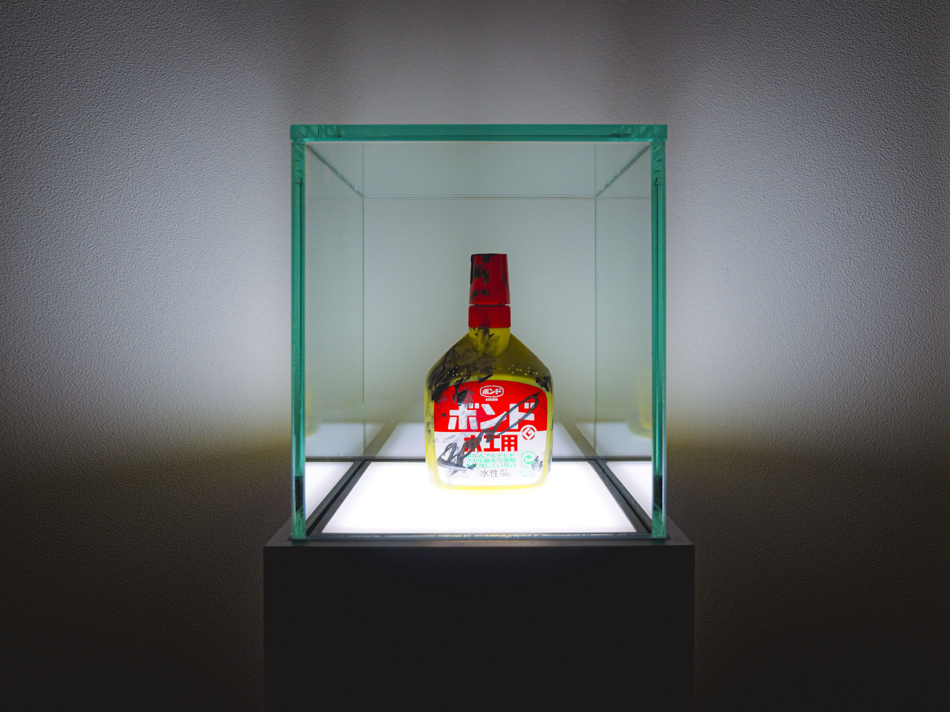 A bottle of liquor in a glass display case.