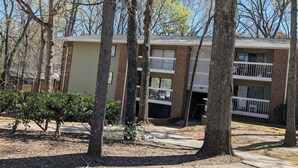 A two-story building with a brick facade and a flat roof. - Reflections - 2bdr condo in Central Raleigh (Raleigh)