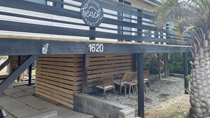 A wooden deck with a sign reading "Resting Beach Face" and the number 1620. - Private Heated Pool and Hot Tub, across the street from the ocean! (Oak Island)
