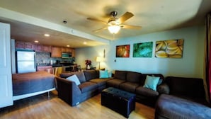 A compact living space with a kitchenette, a sofa set, a coffee table, and artwork on the walls. - *BBQ*Private Beach*W/D*Self Check-In (McCall)