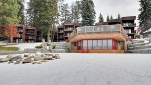 A snow-covered outdoor area with a building featuring a wooden facade and large windows. - *BBQ*Private Beach*W/D*Self Check-In (McCall)