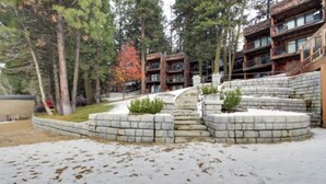 A snow-covered outdoor area with a stone staircase leading to a building with multiple balconies. - *BBQ*Private Beach*W/D*Self Check-In (McCall)