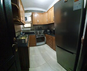 Fridge, electric kettle, cookware/dishes/utensils, dining tables
